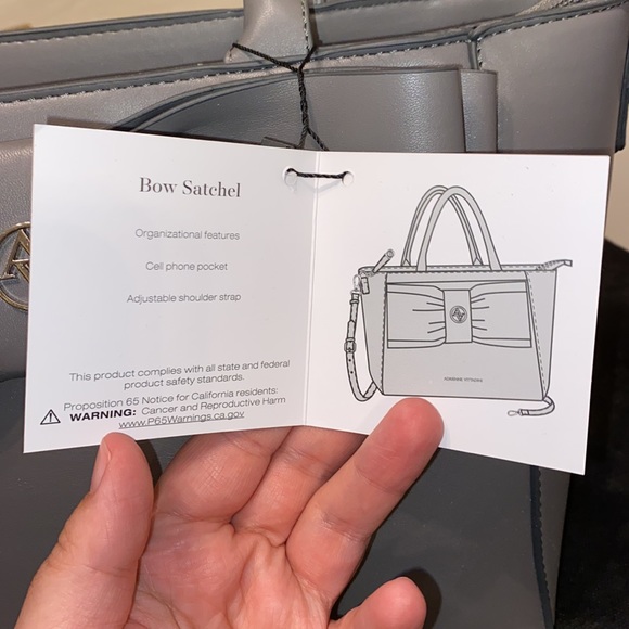 Purse with bow design on front. Brand new with tag. Gray purse. - Picture 10 of 16